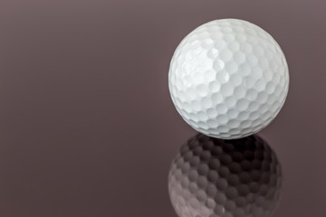 Close up the new white golf ball with the reflection, sport concept.