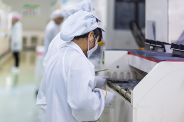 workers and machinery in a solar panel manufacturing industry factory.