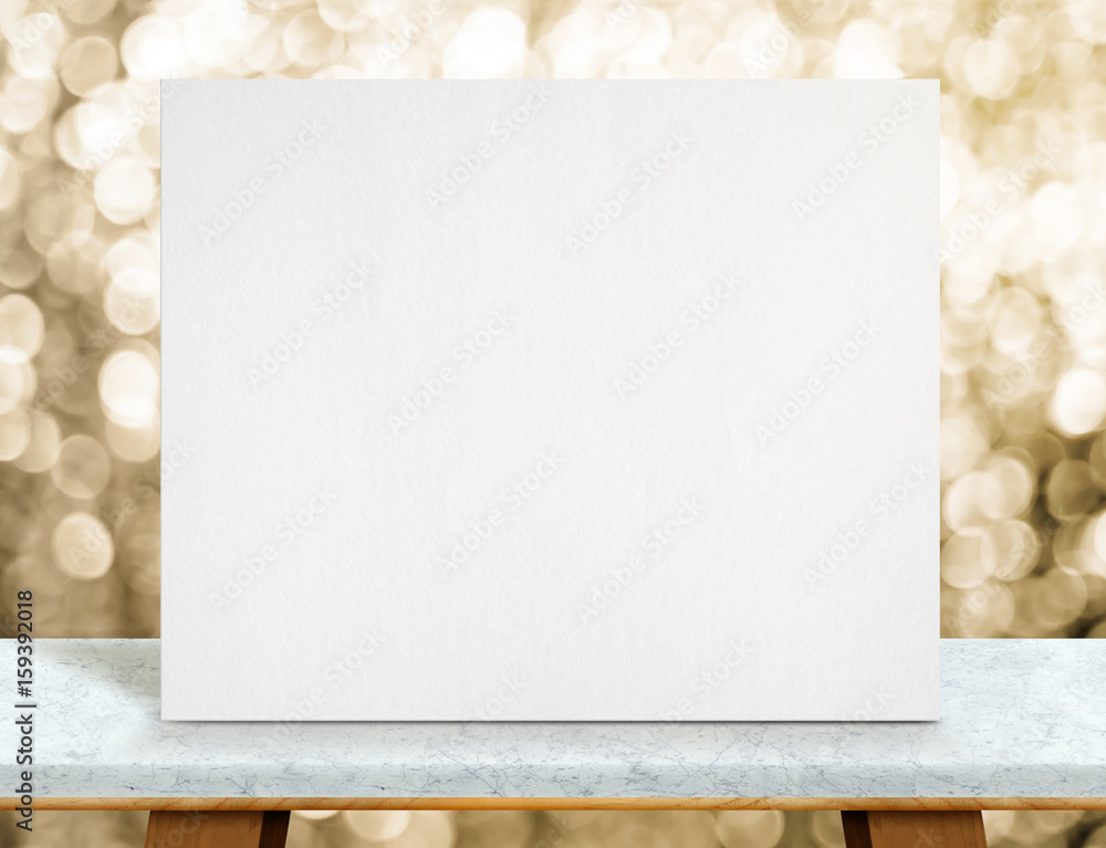 Poster blank white paper poster on marble table top and sparkling gold bokeh light,mock up to display or mo