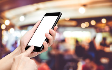 Hand click mobile phone to order with blur customer eating in restaurant background bokeh light,White screen mock up template for adding your logo or your text
