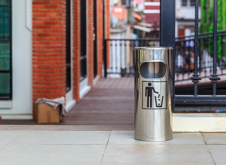 Metal Trash Can with Litter Icon, selective focus