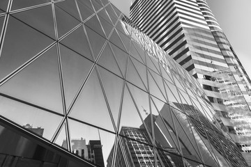 Reflection of urban skyline on modern office building