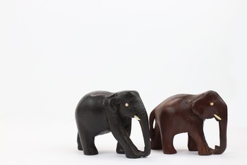 hand carved wooden elephants standing isolated on white background 