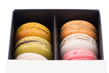 Colorful macaroons. Sweet macarons in the box on white background.