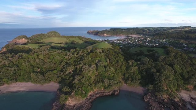 Scenic aerial view towards Matapouri over forest and white sand bays