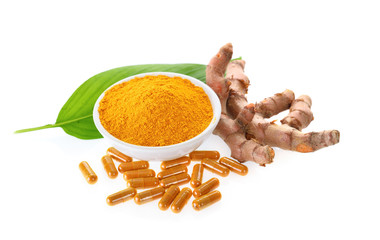 Turmeric powder and capsule on white background