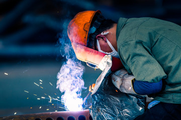 Worker doing electric welding,factory manufacturing,industry concepts.