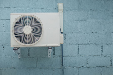 Condenser air conditioner with vintage brick background