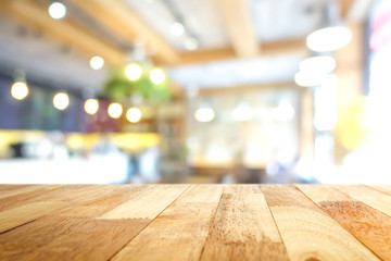 Wood table top in blur cafe interior background