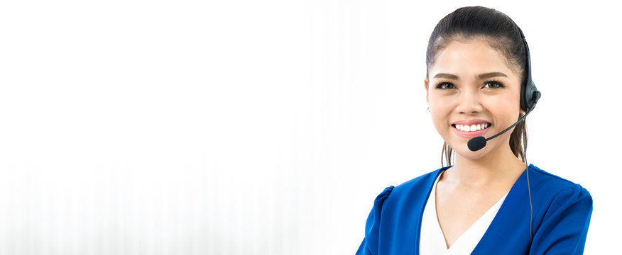 Smiling woman wearing microphone headset as an operator, telemarketer or call center staff