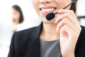 Woman with  microphone headset as an operator in call center