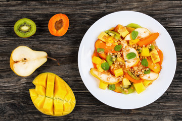fruit salad  sprinkled with muesli on plate