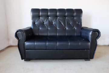 black leather sofa in empty room