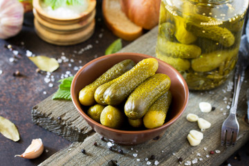 Marinated cucumbers gherkins. Pickles with mustard and garlic on a stone background. © elena_hramowa