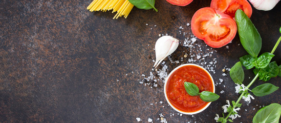 Culinary background for cooking pasta, tomato sauce, fresh herbs and spices. Copy space.