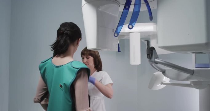 The technician puts the patient in a protective vest before the procedure x-rays