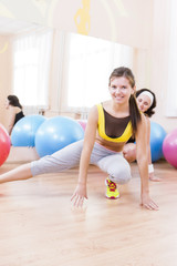 Sport, Fitness, Healthy Lifestyle Concepts.Two Female Caucasian Athletes in Good Fit Posing With Fitballs in Sport Gym.