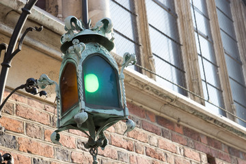 Gothic lantern on the facade of the old brick buildings
