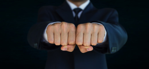 Businessman, fists forward.