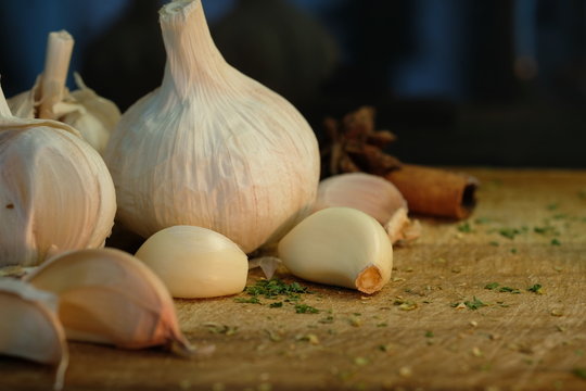 Fresh garlic on a wooden background. Vintage image style .