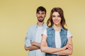 Happy brother and sister over yellow background