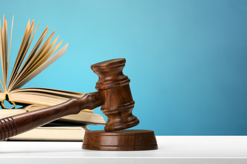 Wooden gavel and books on wooden table