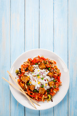 Rice noodles with meat, sauce and vegetables 