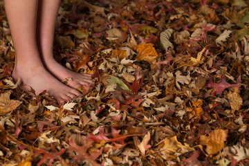 barefoot in autumn leaves