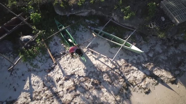 Bohol - April 2017: Aerial view of pump boats with long shadows on white sand beach than tilting to the sea. Philippines.