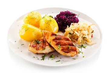 Grilled chicken fillet with boiled potatoes on white background 