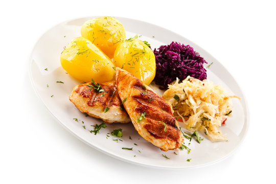 Grilled chicken fillet with boiled potatoes on white background 