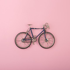 Sport concept - toy bicycles on pink background