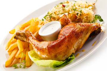 Roast chicken leg with french fries on white background