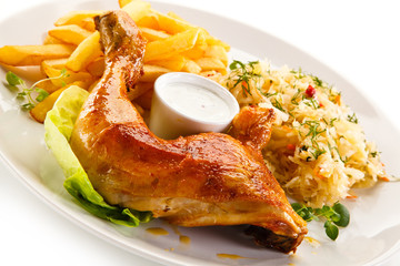Roast chicken leg with french fries on white background