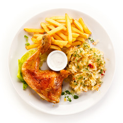Roast chicken leg with french fries on white background
