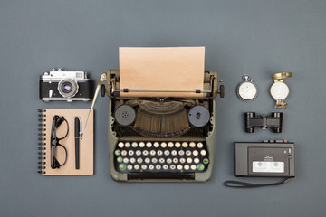 Journalist or private detective workplace - typewriter, camera, recorder and other stuff