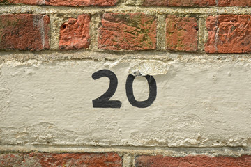 House number 20 sign painted on wall
