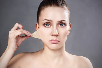 Woman remove her old dry skin from face.