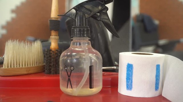 Barbershop: hairdresser's tools lying on a red tabele.