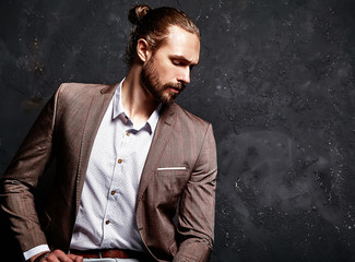 portrait of handsome fashion stylish hipster businessman model dressed in elegant brown suit...