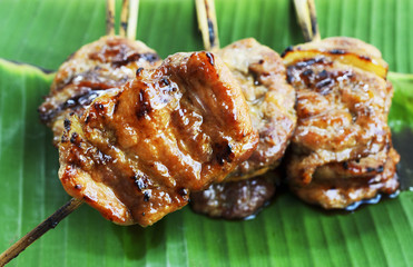 Grilled pork or mooping thai local food on banana green leaf