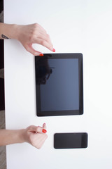 white tablet with a blank screen in the hands
