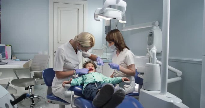 Oral examination of the child by the dentist . Modern dental office