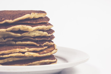 A stack of plain pancakes on a white plate background. isolated