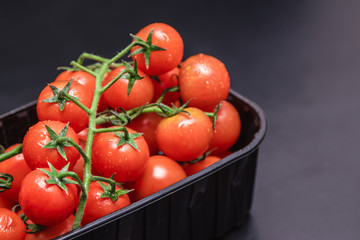 Cherry tomatoes in a plastic container.