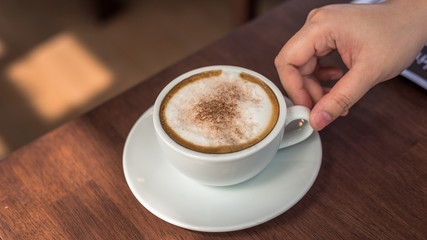 Hand Holding Hot Coffee Cappuccino