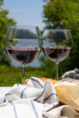 Red wine in glasses and baguettes.