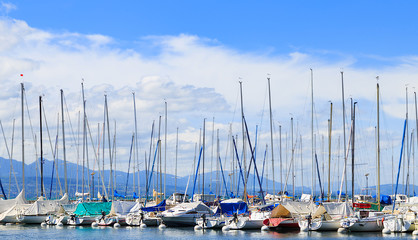 Part of yachts and boats at Ouchy port with the blue spring sky on the background. Lausanne, Switzerland