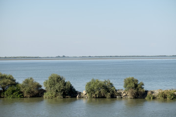 Landscape with the water channel between Danube Delta and Black Sea, Romania, in a summer sunny day