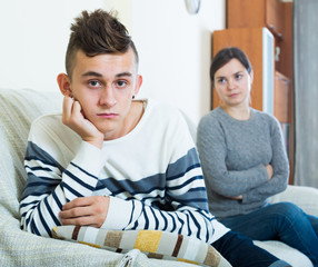 Frustrated  mother and angry teen quarrelling  in domestic interior